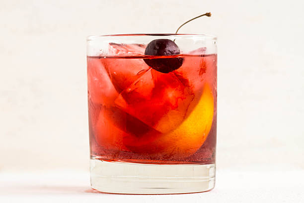 Old fashioned cocktail Old fashioned cocktail on white wooden background cherry colored stock pictures, royalty-free photos & images