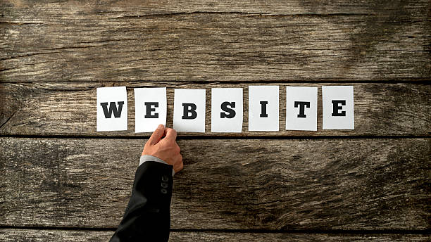 istock Overhead view of male hand assembling the word Website 495537968