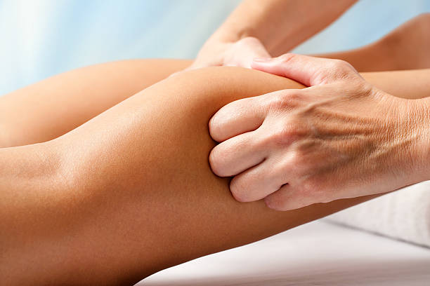 istock Physiotherapist hands massaging calf muscle. 495539920