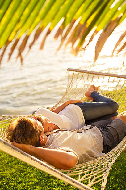istock Couple relaxing in tropical hammock 495540495