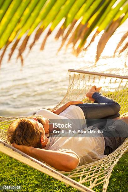 Couple Relaxing In Tropical Hammock Stock Photo - Download Image Now - Adult, Barefoot, Beach