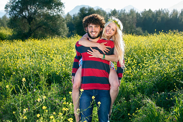 istock Playful young couple in a yellow rapeseed field. 495540595