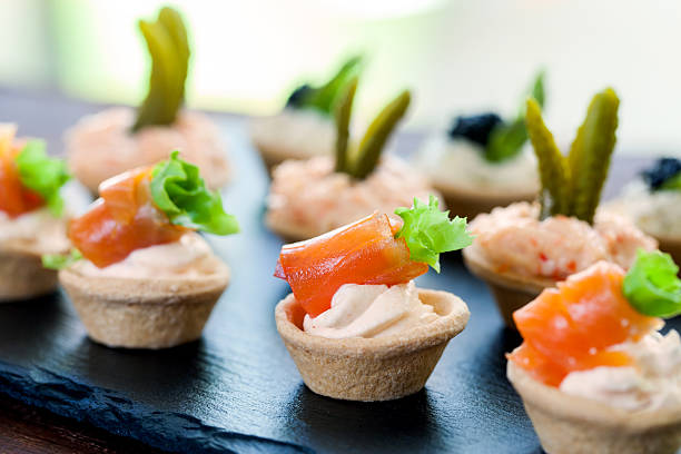 istock Mini puff pastry tartlets with smoked salmon filling. 495540848