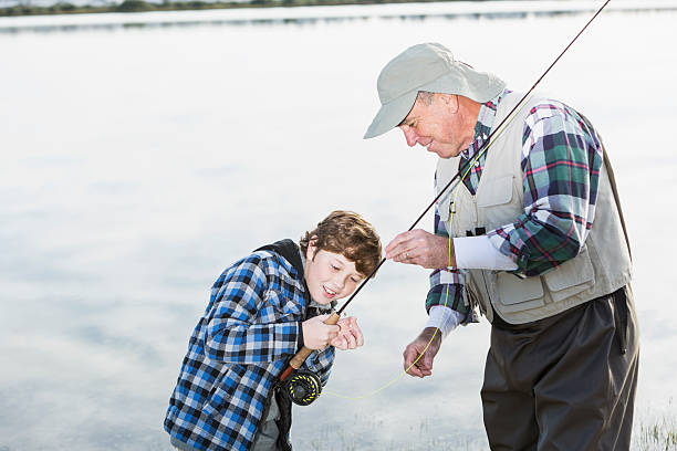 istock Boy fishing with grandfather 495541087