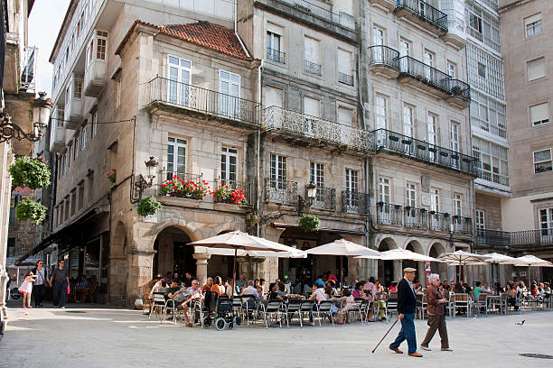 Constitución square in old town Vigo, Galicia, Spain. Vigo, Spain - June 4, 2011: Constitución square in old town Vigo, Pontevedra province, Galicia, Spain. People walking by or sitting in sidewalk cafes. vigo stock pictures, royalty-free photos & images
