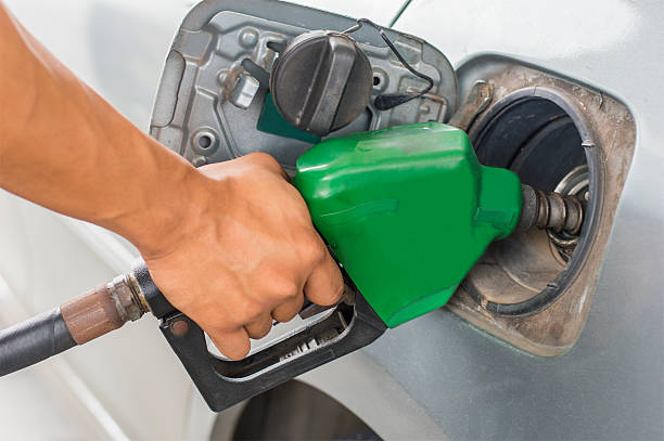 istock hand refilling the car with  nozzle on petrol filling 495544691