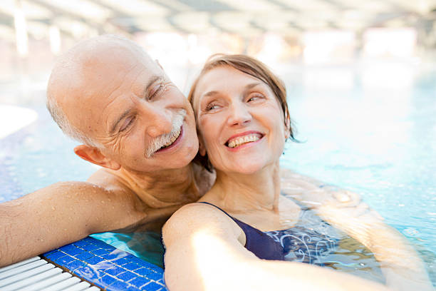 istock senior couple  relaxing in  hotel pool 495545147