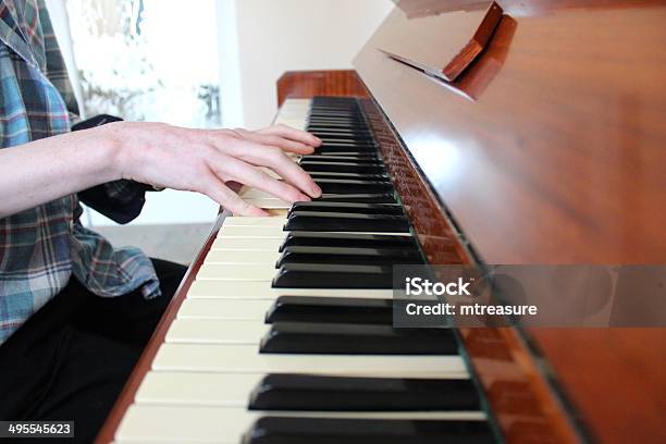 Image Of Teenage Boy Playing The Piano Wooden Piano Keyboard Stock Photo - Download Image Now