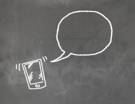 smart phone and speech bubble on the blackboard