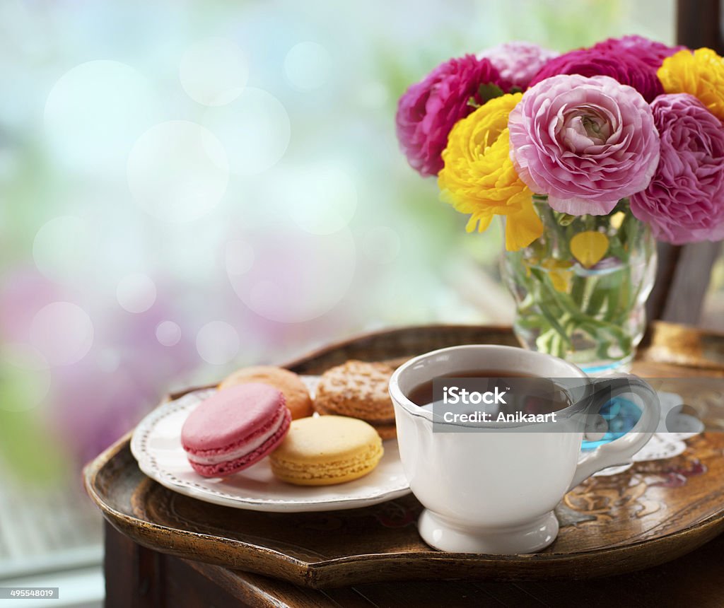 Cup of coffee Cup of coffee with macaroons on a table with flowers ranunculus Backgrounds Stock Photo