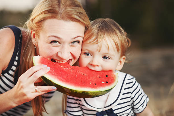 istock Kid at countryside eating watermelon. 495555472