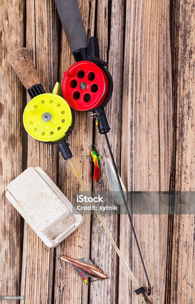 closeup ice fishing tackles and equipment closeup ice fishing tackles and equipment on dry stalk background 2015 Stock Photo
