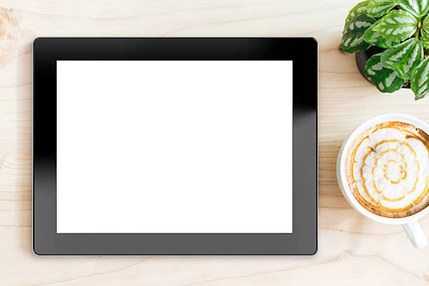 istock tablet white screen on wood desk on top view 495556250