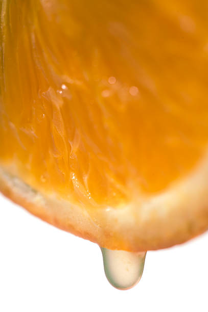 istock Slice of orange fruit with juice, isolated on white 495556330