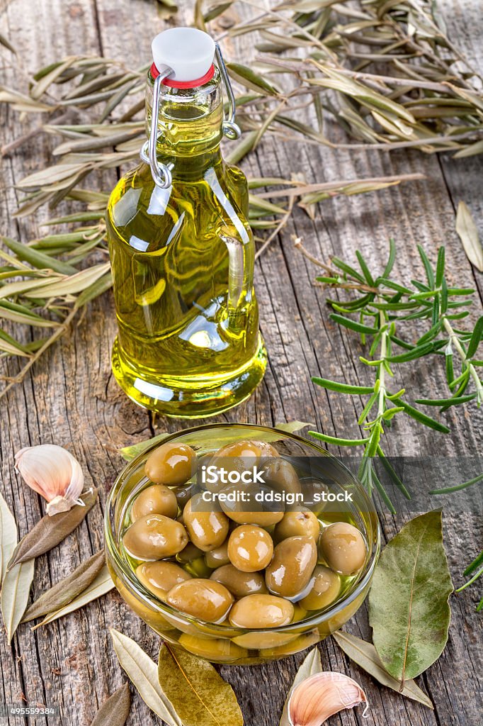 olives in bowl and olive oil olives in a bowl and olive oil on an old rustic table 2015 Stock Photo