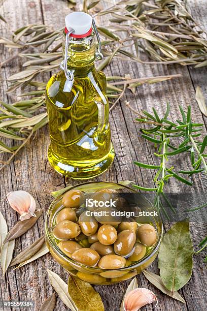 Olives In Bowl And Olive Oil Stock Photo - Download Image Now - 2015, Backgrounds, Basil