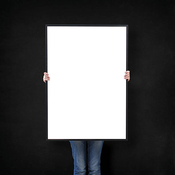 istock woman with blank poster on wall background 495559600