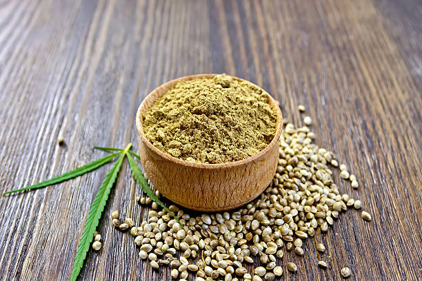 istock Flour hemp in bowl of grain and leaf on board 495562576