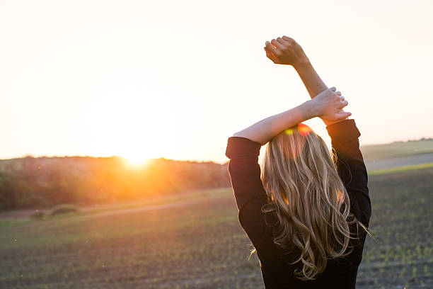 istock Young woman enjoys sun beams 495566103