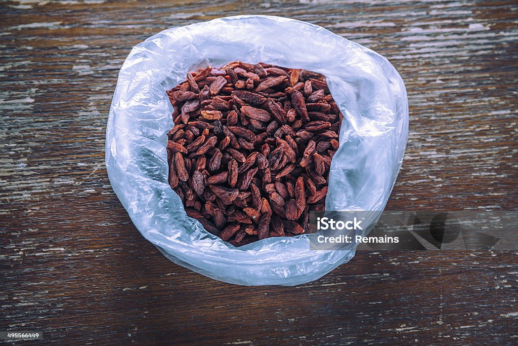 Healthy goji berries Goji berries in the bag on a wooden table Antioxidant Stock Photo