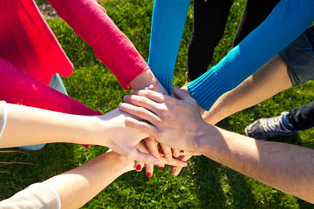 istock Group of friends pile up hands as unity oath 495567777