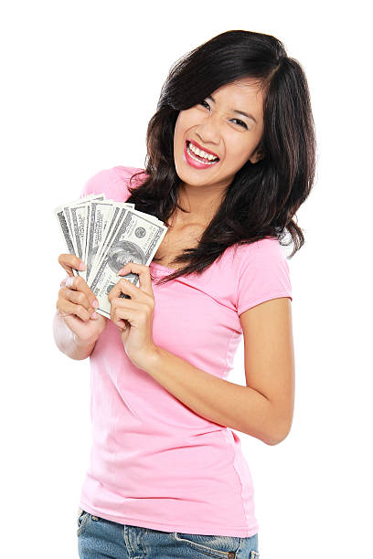istock woman showing money isolated on white background 495568631