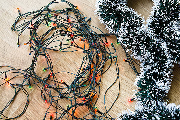 istock Light and decorative garlands on wooden background 495576176
