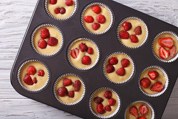 istock Preparation strawberry muffins closeup. horizontal top view 495577424