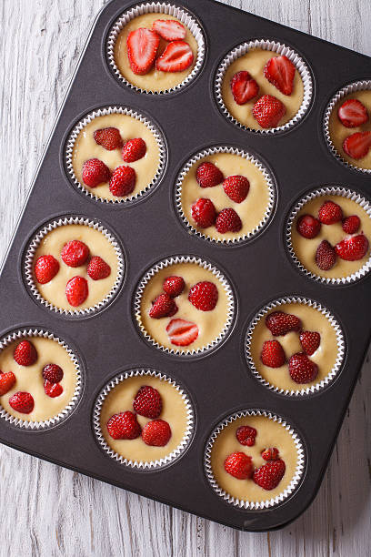 istock cooking delicious strawberry muffins in baking dish closeup top 495578196