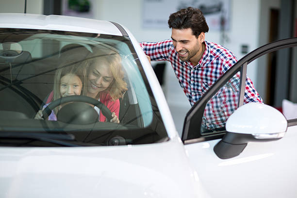 istock car salesman handshaking with cheerful buyer 495579316