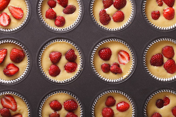 raw strawberry muffins in baking dish horizontal top view