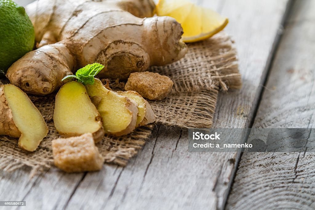 Ginger lemon mint honey on rustic wood background Ginger lemon mint honey on rustic wood background, copy space 2015 Stock Photo