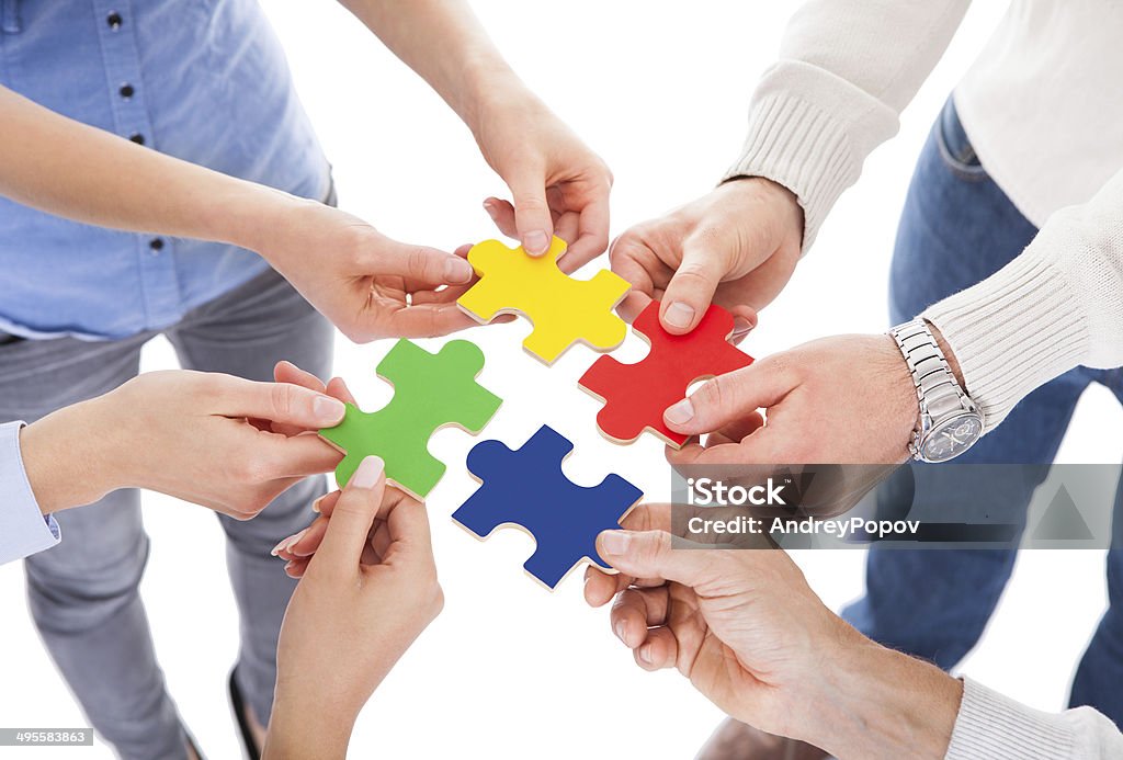 Five People Hand With Puzzle Close-up Of Five People Hand Holding Colorful Puzzle Over White Background Four People Stock Photo