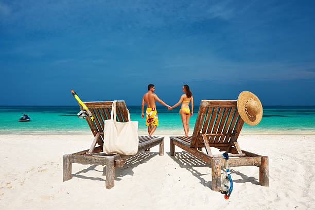 istock Couple in yellow on a beach at Maldives 495584685