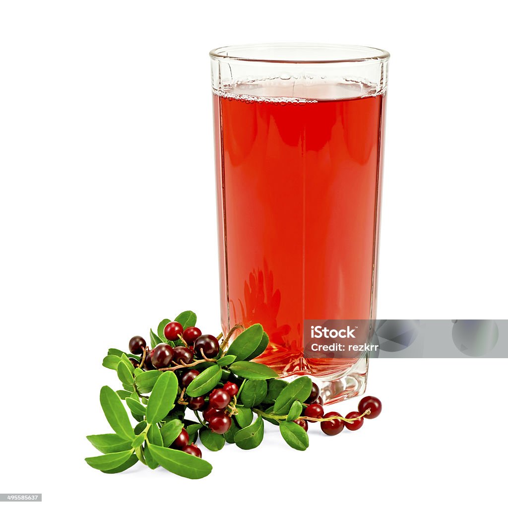 Juice cowberry with berries Cowberry juice in a tall glass, a bunch of twigs cowberry with green leaves and berries isolated on white background Berry Fruit Stock Photo