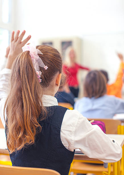 istock Girl and teacher on a lesson at school 495587577
