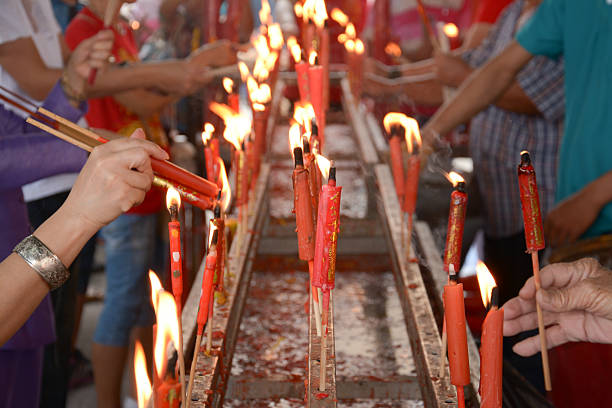 istock hand cense joss stick to incense burne and burning candle 495587751