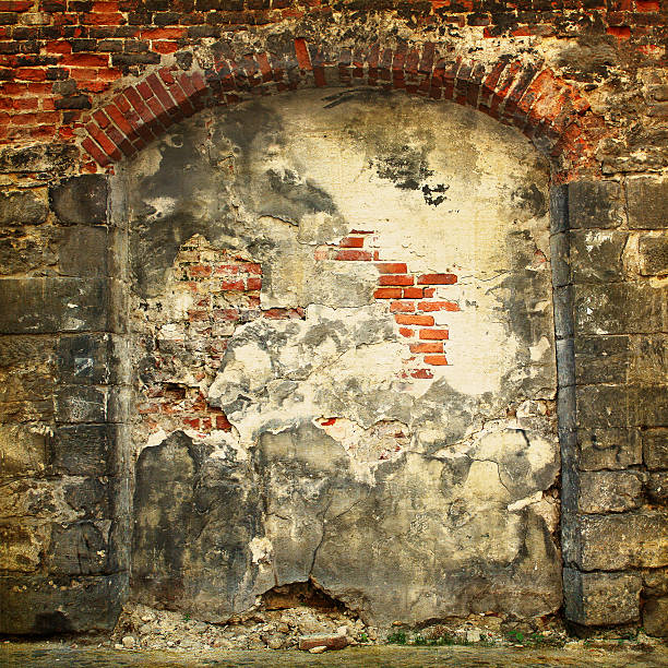 istock Collapsing stone wall of an old house with brick masonry 495587821