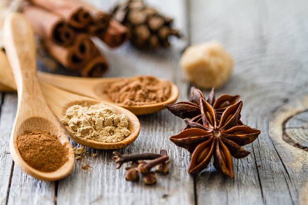 istock Selection of christmas spices on rustic wood background 495589772