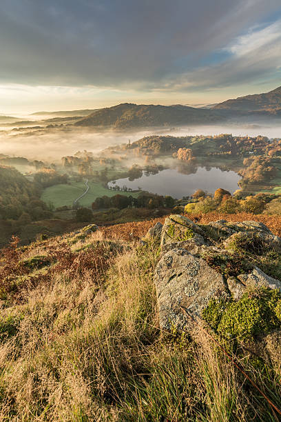 istock Stunning Golden Light Lighting Lingering Fog Over Loughrigg Tarn. 495589846