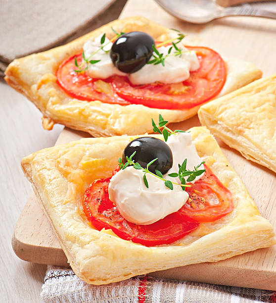 Mini puffs with tomatoes, cheese and olives