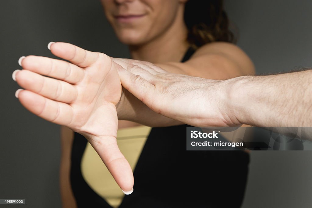 Chiropractor examining patient Chiropractor examining muscles in patient's arm Adult Stock Photo