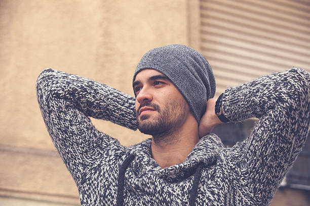 istock Handsome young man standing by the wall 495591618