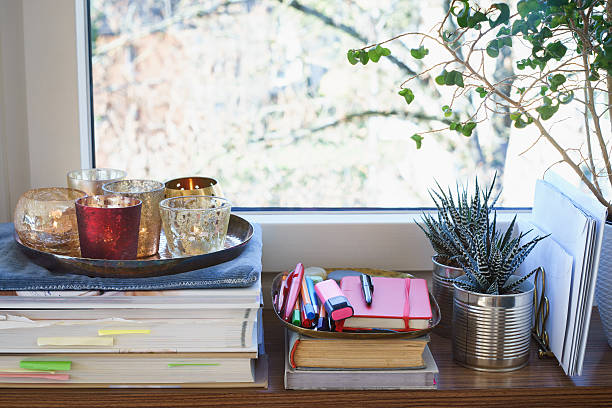 istock Books, candles, writing materials and plants on a windowsill 495592042