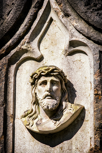 old jesus christ relief at a historic gravestone
