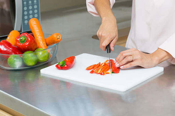 istock Closeup on woman cutting fresh vegetables 495593086