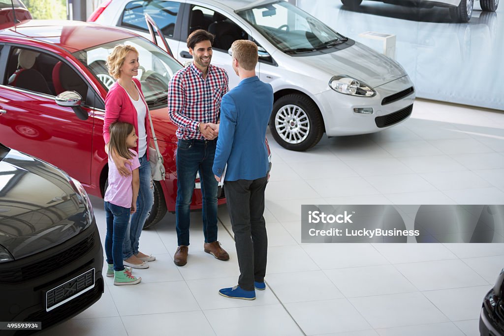 car agent congratulate the family car agent handshake with his daddy and congratulate the family on buying car Car Stock Photo