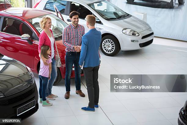 Car Agent Congratulate The Family Stock Photo - Download Image Now - Car, Car Dealership, Shopping