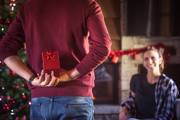 Man giving present to girlfriend stock photo