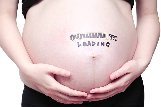 Pregnant belly Human abdomen, hands holding his stomach. 8 months pregnant stock pictures, royalty-free photos & images